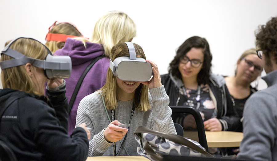 Families experience the technology room in the College of Education and Professional Studies where education students are taught simple computer coding to develop classroom activities for elementary school children.