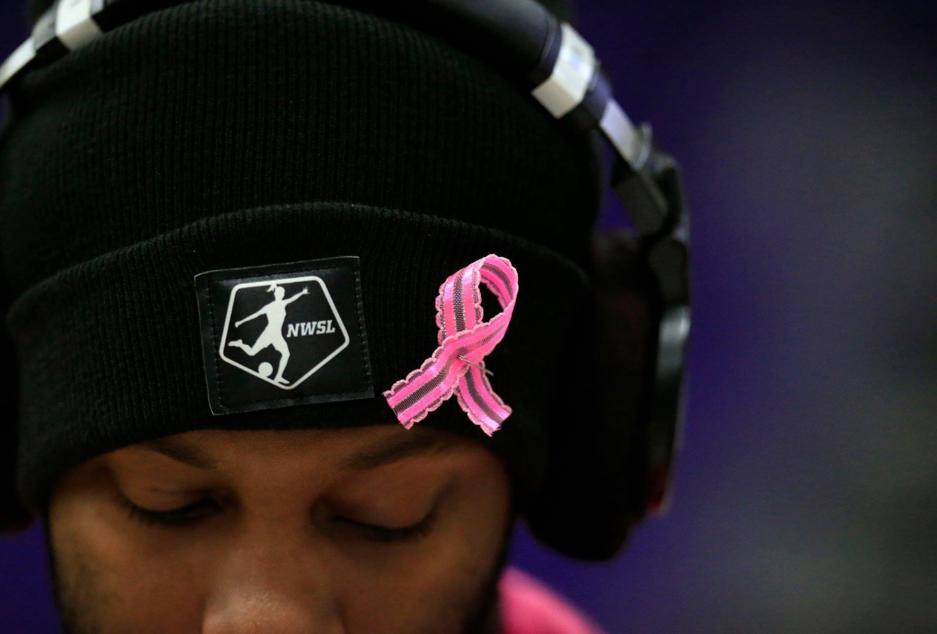 Moore, who was operating a camera for UWW-TV, wears a pink ribbon for breast cancer awareness as the UW-Whitewater women's basketball team defeated UW-Eau Claire 68-55 on Saturday, Feb. 2, 2019, at Kachel Gym.