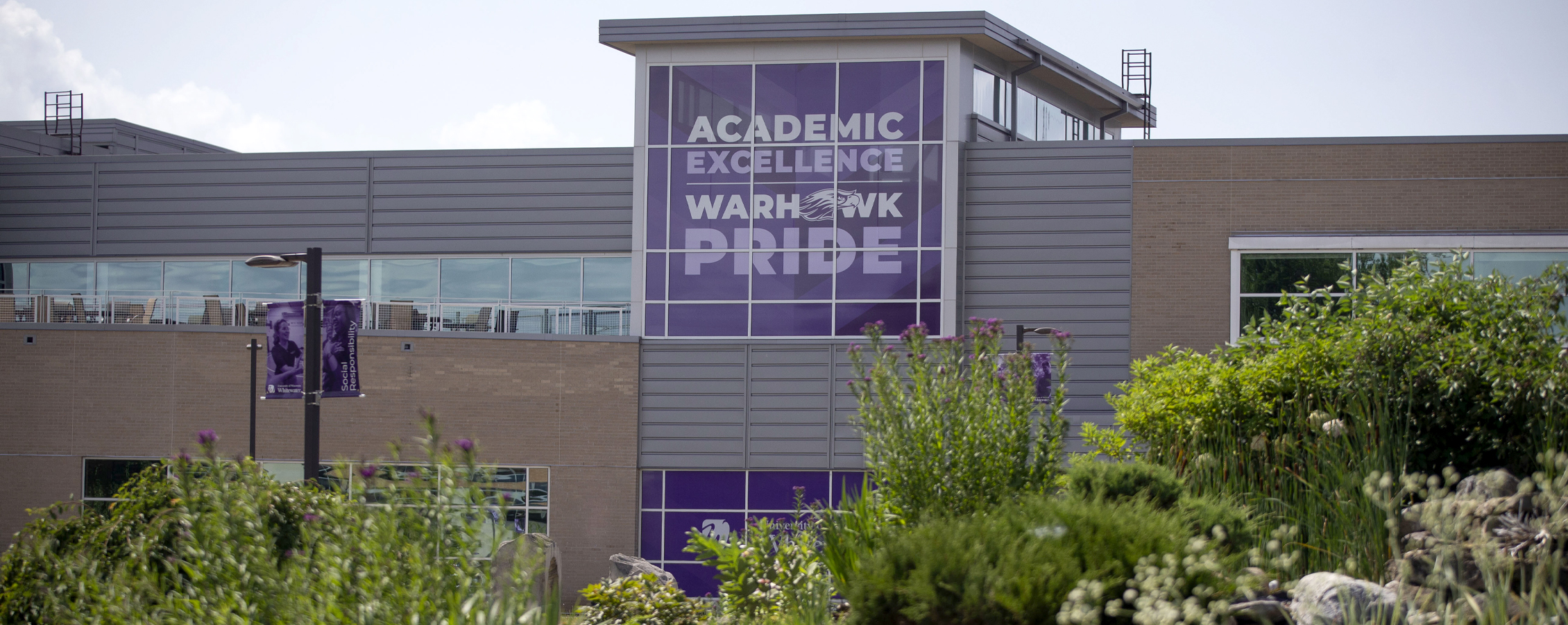 The University Center with a purple banner that says Academic Excellence and Warhawk Pride.
