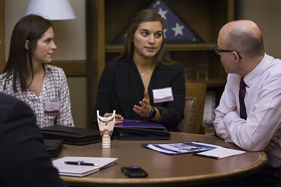 Two students speak with a Wisconsin State Representative.
