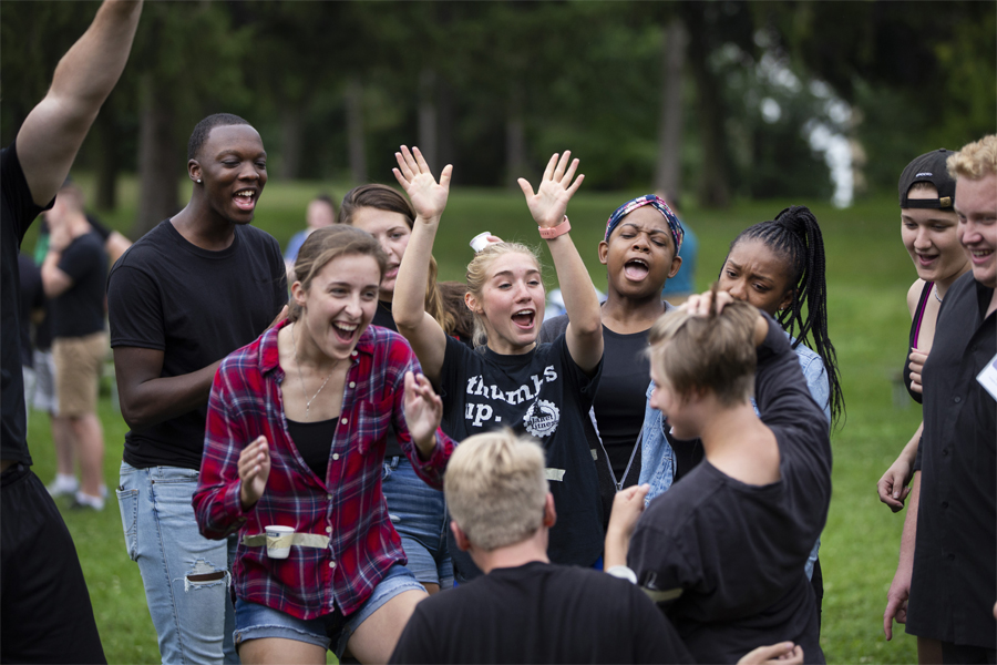 A group of students cheer together outdoors.