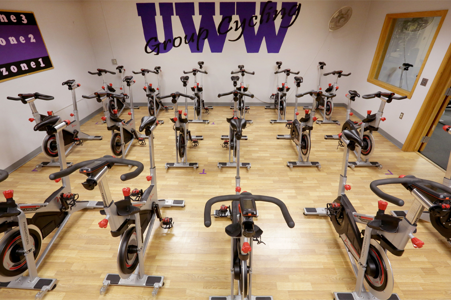 Cycling room with bikes and UWW in purple on the wall.