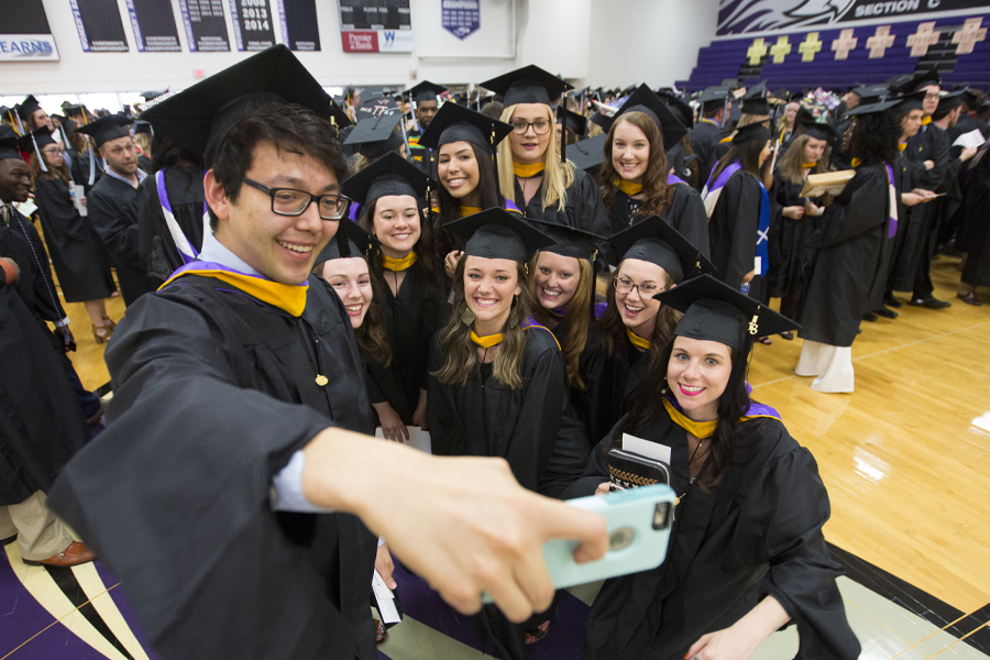 Students gather for a selfie at Commencement.