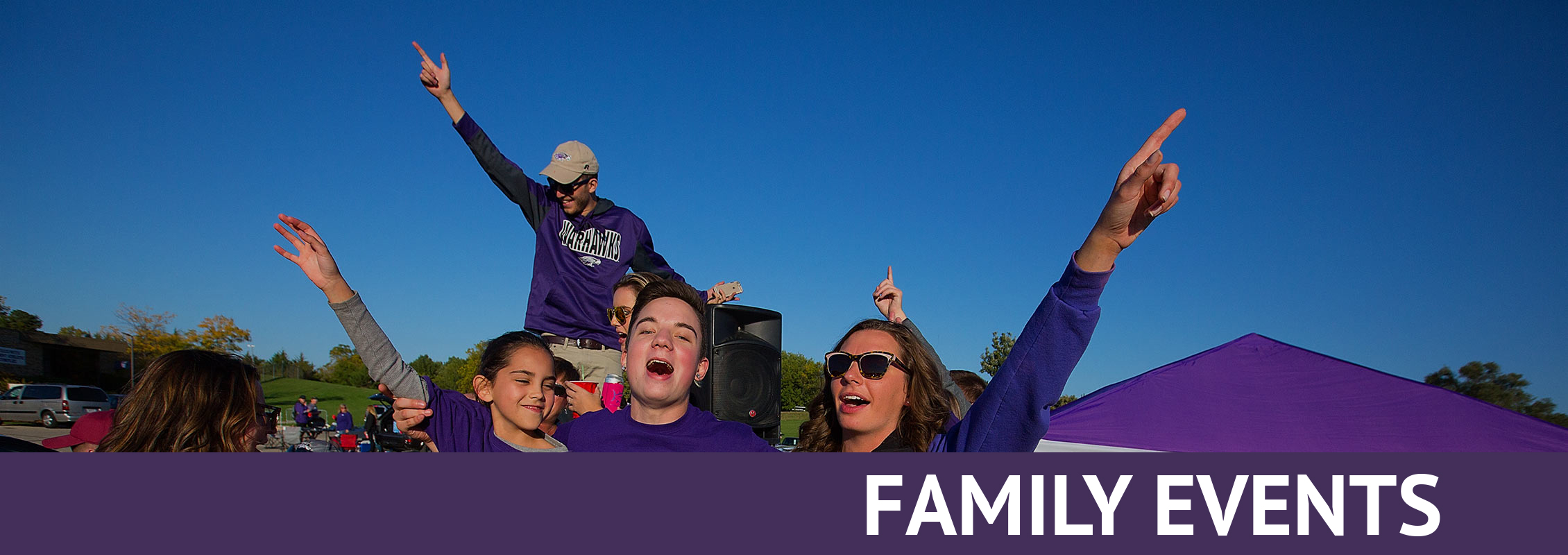 Family Events: A family dressed in purple singing or shouting, arms in the air