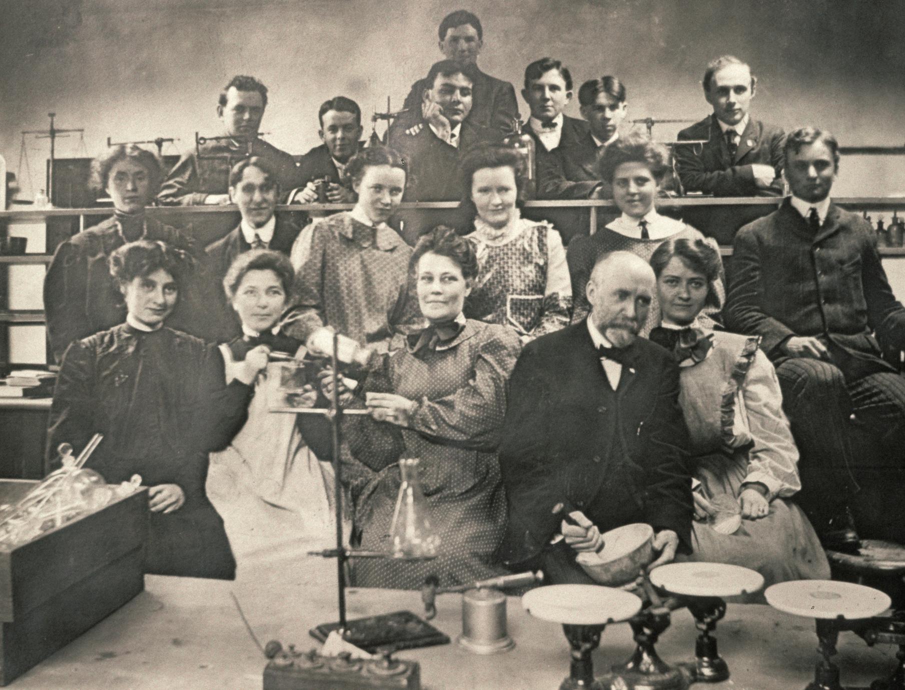 Arthur Upham (holding mortar and pestle) with science class