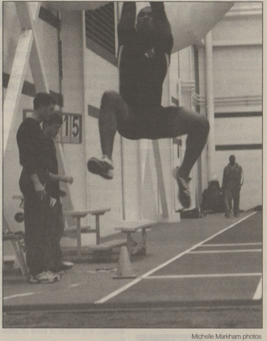 Derek Stanley soaring through air at a long jump event