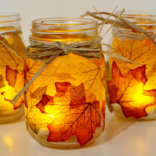 image of leaves glued onto a jar, holding a small candle
