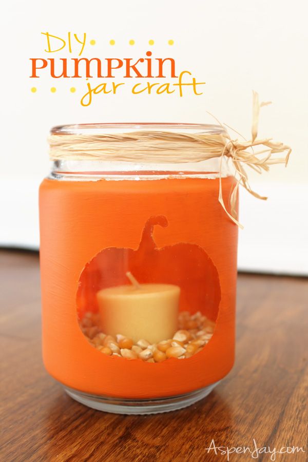 image of a pumpkin stenciled onto a jar, holding a small candle