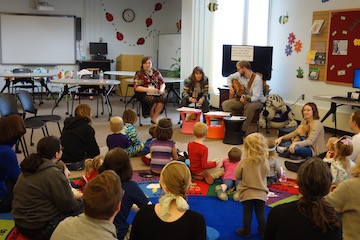 Children gather for a sing-a-long during the Stuffed Animal Sleepover