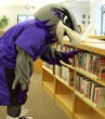 Photo of UWW mascot browsing books
