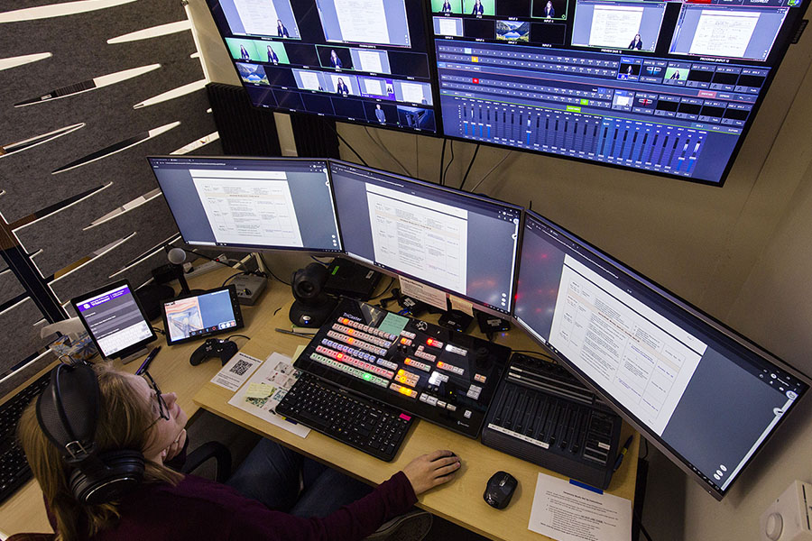 Student works online with several monitors.