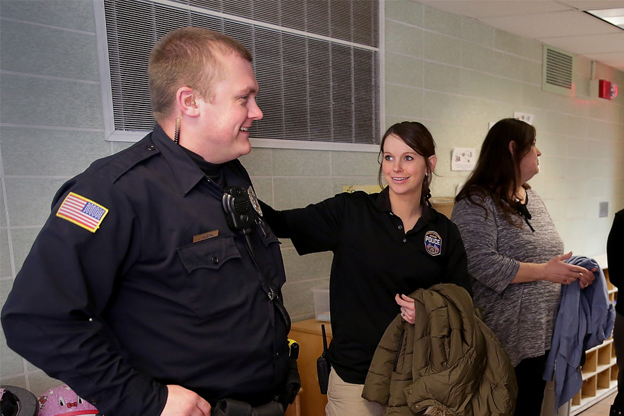 UW-Whitewater police officer Josh Kuehl, left, wears an in-ear communication device.