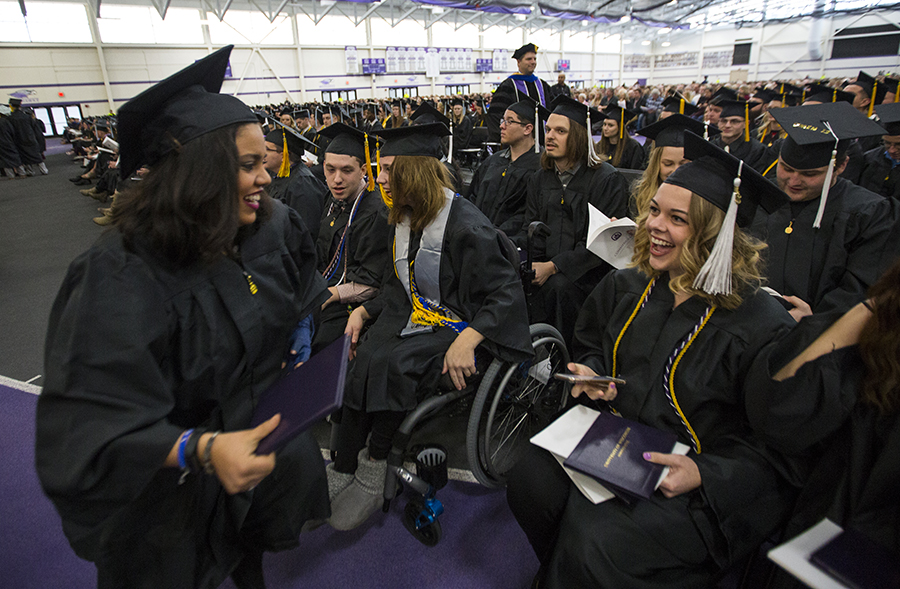 Students in cap and gowns at graduation.