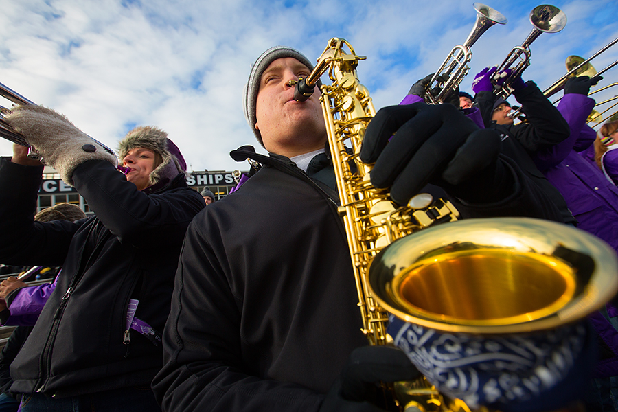 Ryan Schultz, of the Warhawk Marching Band, playing instrument at football game