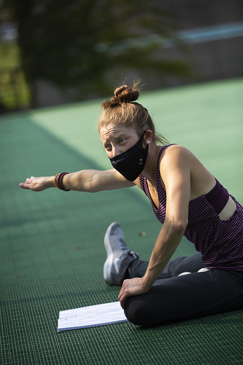 Piper Morgan Hayes stretches on the tennis courts.