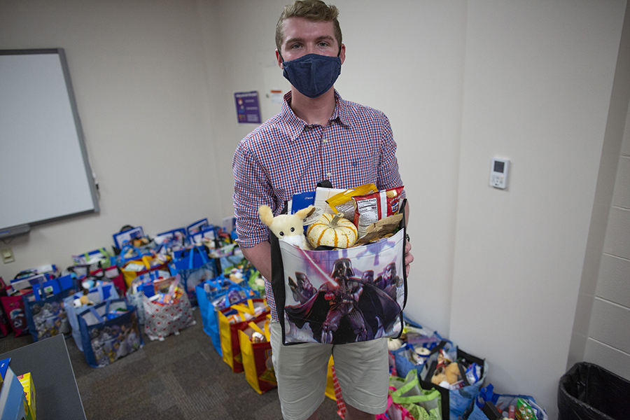 Dylan Paprocki, a finance major from Johnsburg, Illinois, holds a care bag.