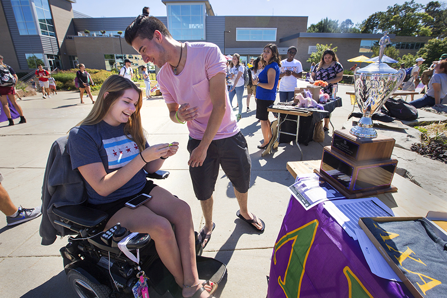 Two students share a smile on the mall of the UW-Whitewater campus.