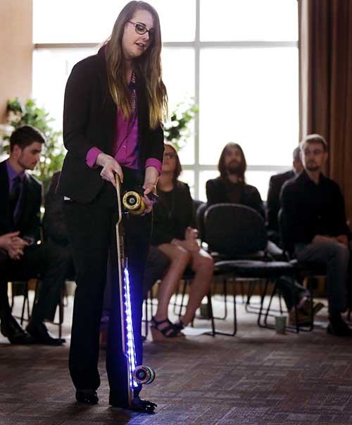 Kristen Holtan demonstrates a longboard with LED lights.