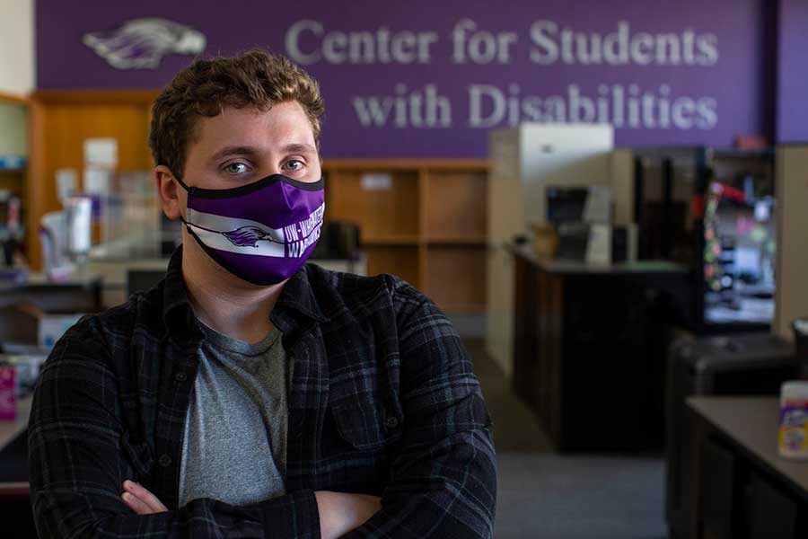 Thomas Hamilton stands in the office of the Center for Students with Disabilities.