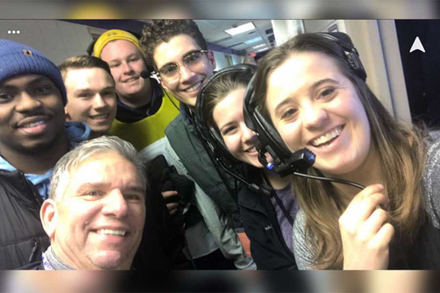 Annmarie Lavorata with other students in a broadcast booth.