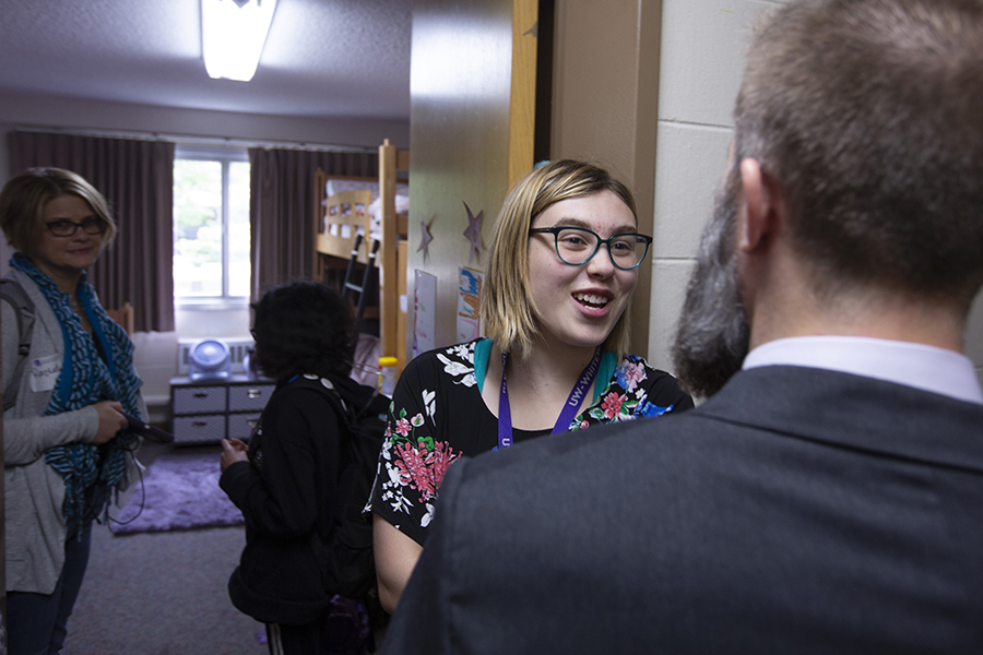 A LIFE student talks with the program's creator outside of a dorm room.