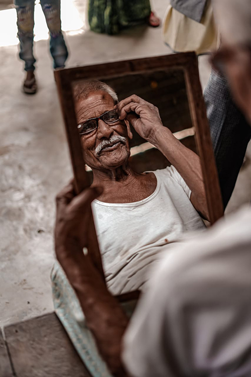 A man looks at himself in the mirror.