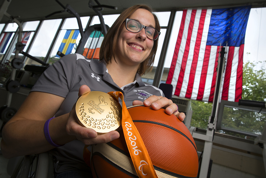 Christina Schwab holds a gold medal and a basketball.