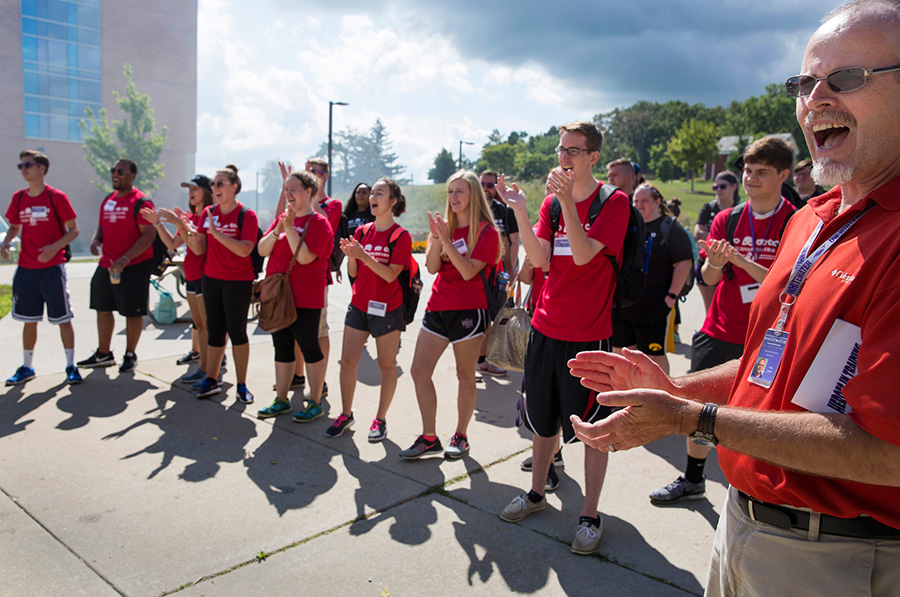 People stand outside in red shirts.