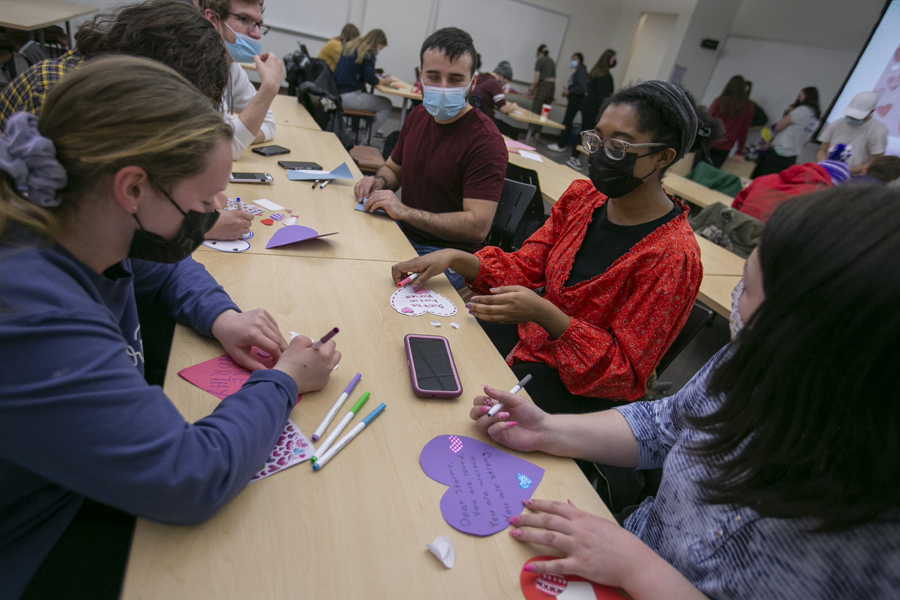 Students gather around a table with Valentine's.