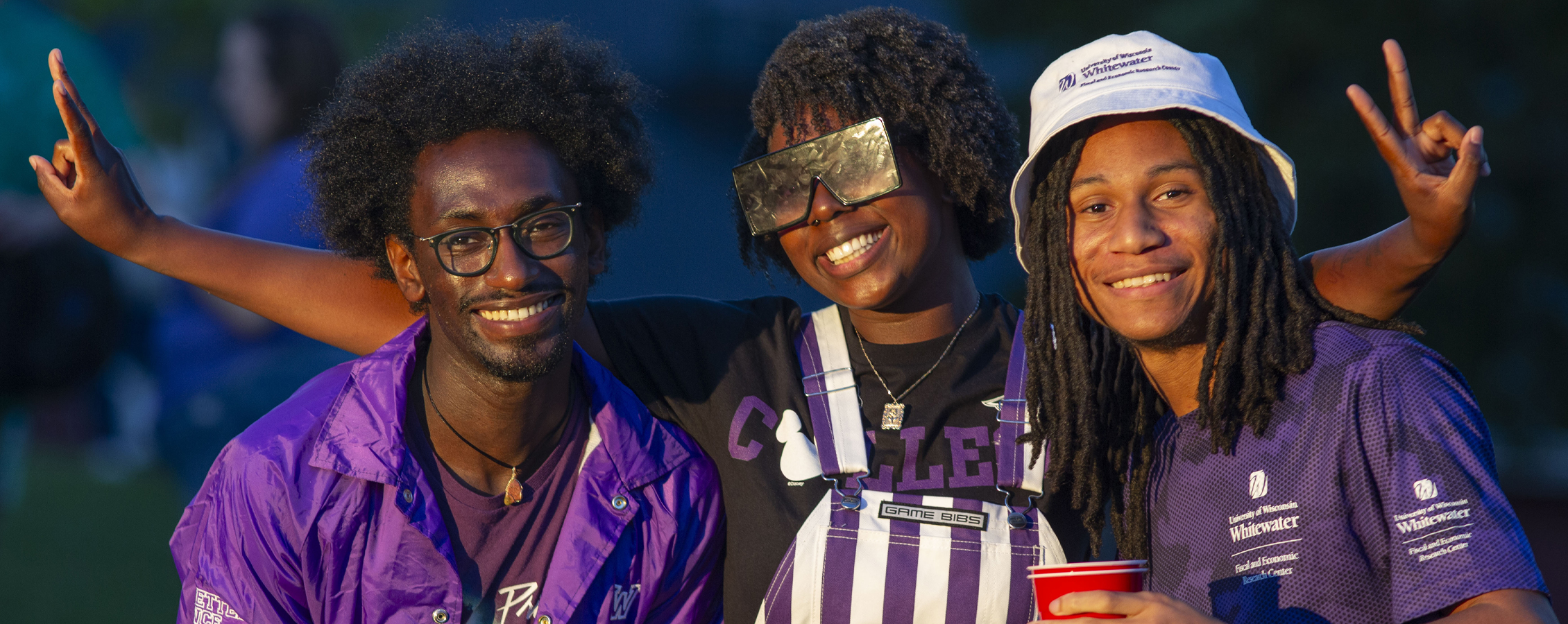 Three students pose together for a photo.