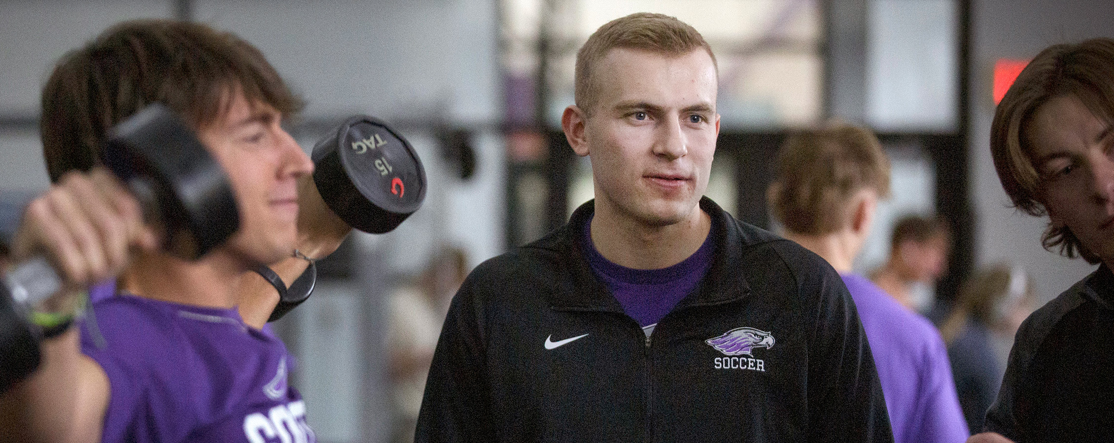 A student lifts weights in the Williams Center weight room.