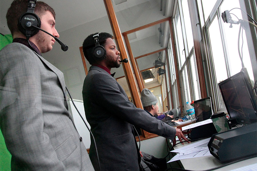 Communication majors at the University of Wisconsin Whitewater work with electronic media at the football game.