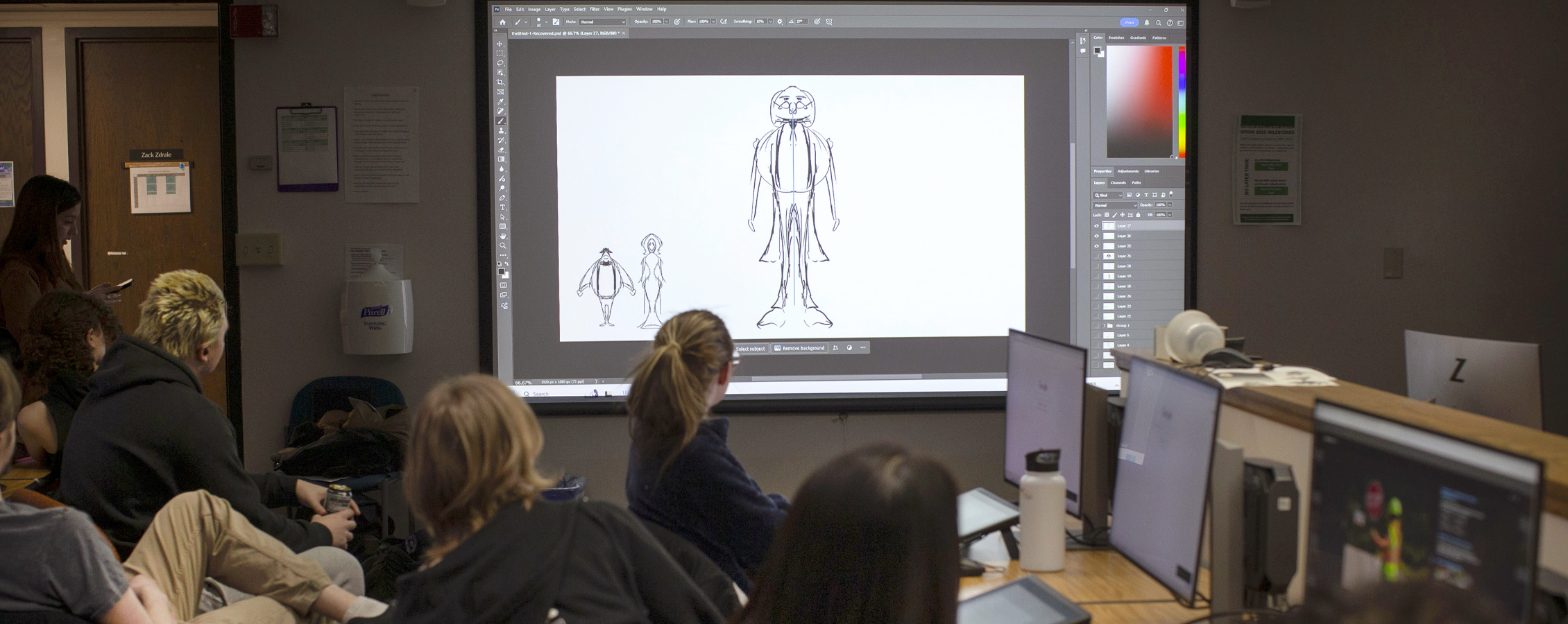 Art and design students look at small models during a class exercise on the University of Wisconsin Whitewater campus.