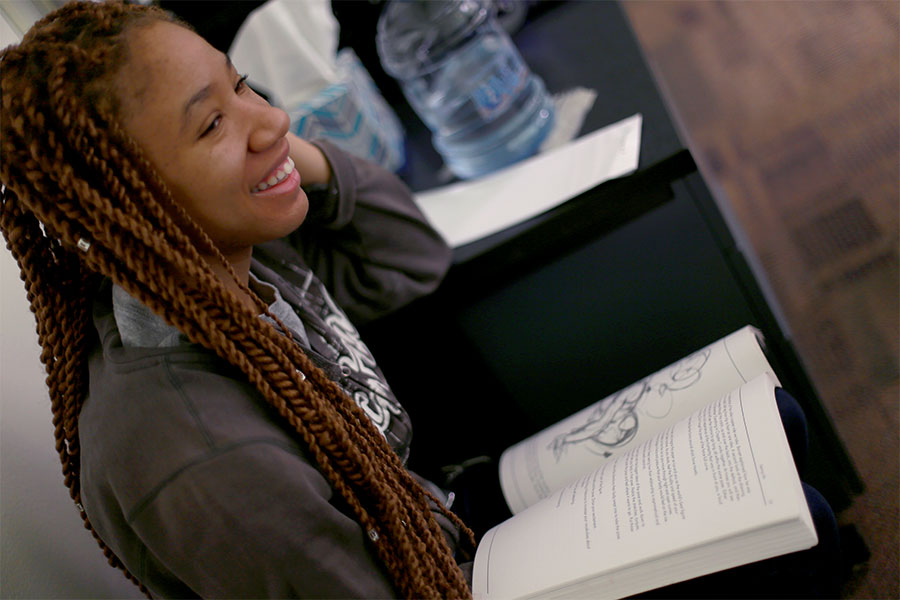 A student reads a book on the UW-Whitewater campus.