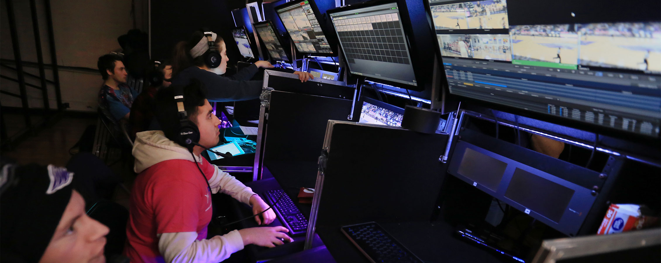 Students work with several monitors to broadcast a basketball game at UW-Whitewater.