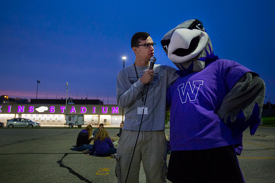 A student interviews Willie Warhawk outside of Perkins Stadium.