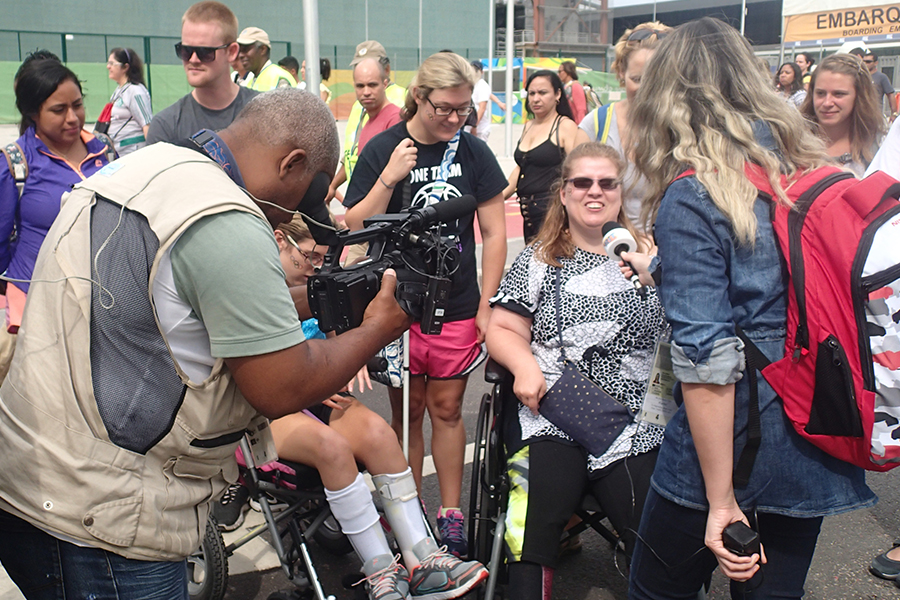 Two journalism students interviewing a group of fans who were gathered outside the Rio Paralympic games on UW-Whitewater’s first Diversity in Sports travel study.