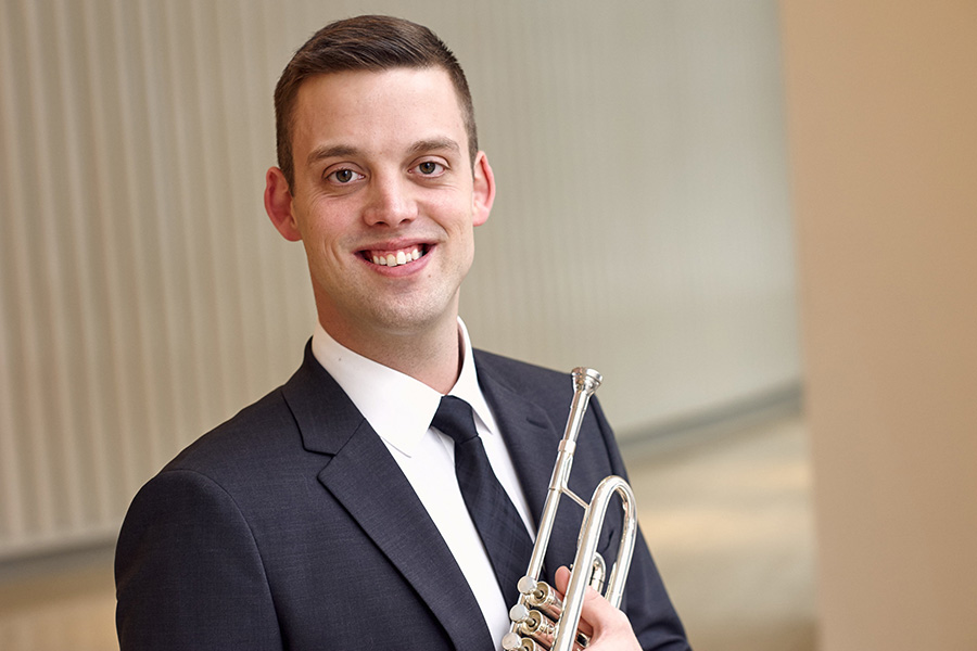 Matthew Onstad holds a trumpet.