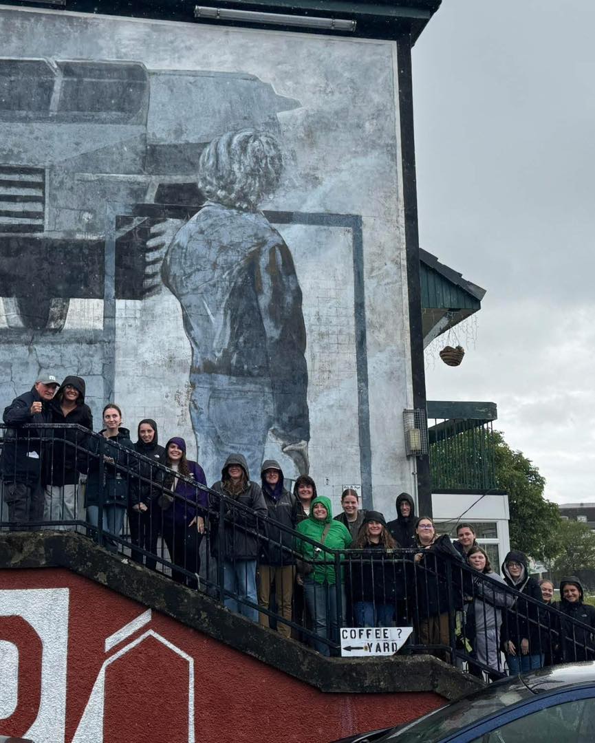 UW-Whitewater students in front of a mural in Derry, Ireland