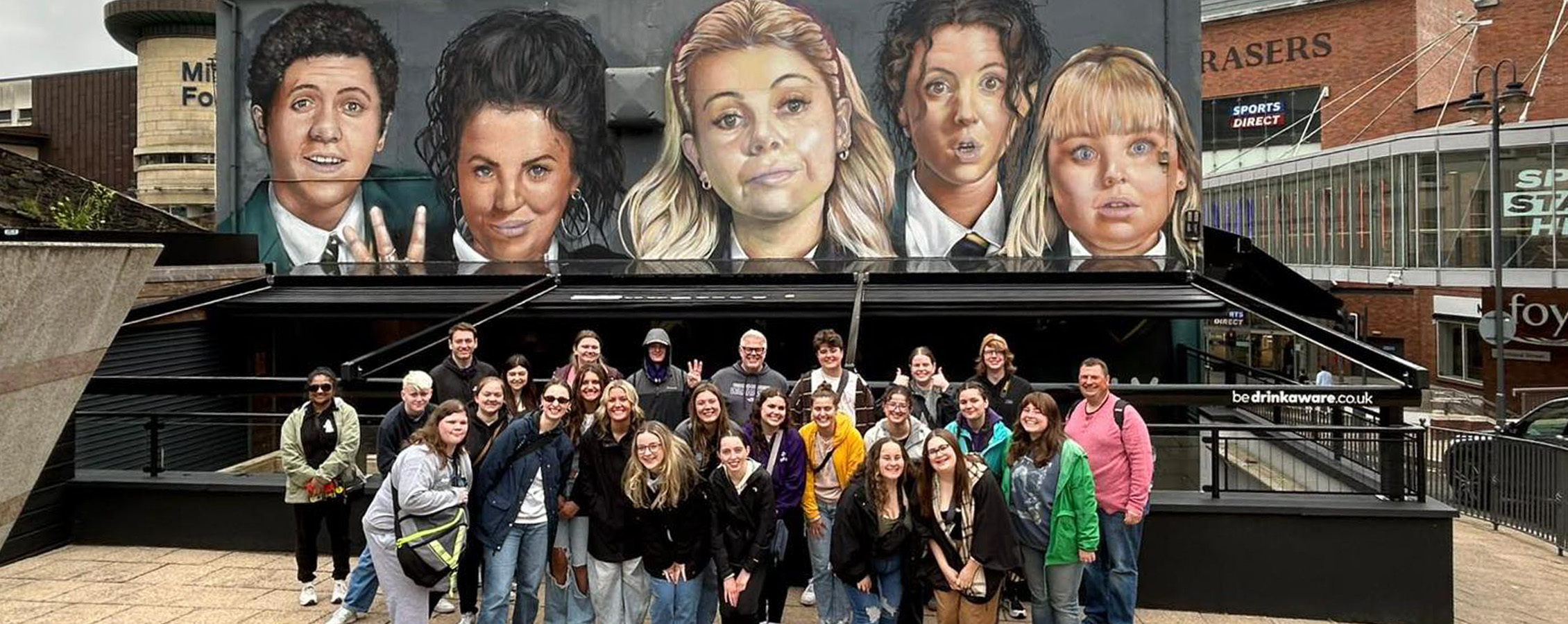 UW-Whitewater students in front of a pop culture mural in Derry, Ireland