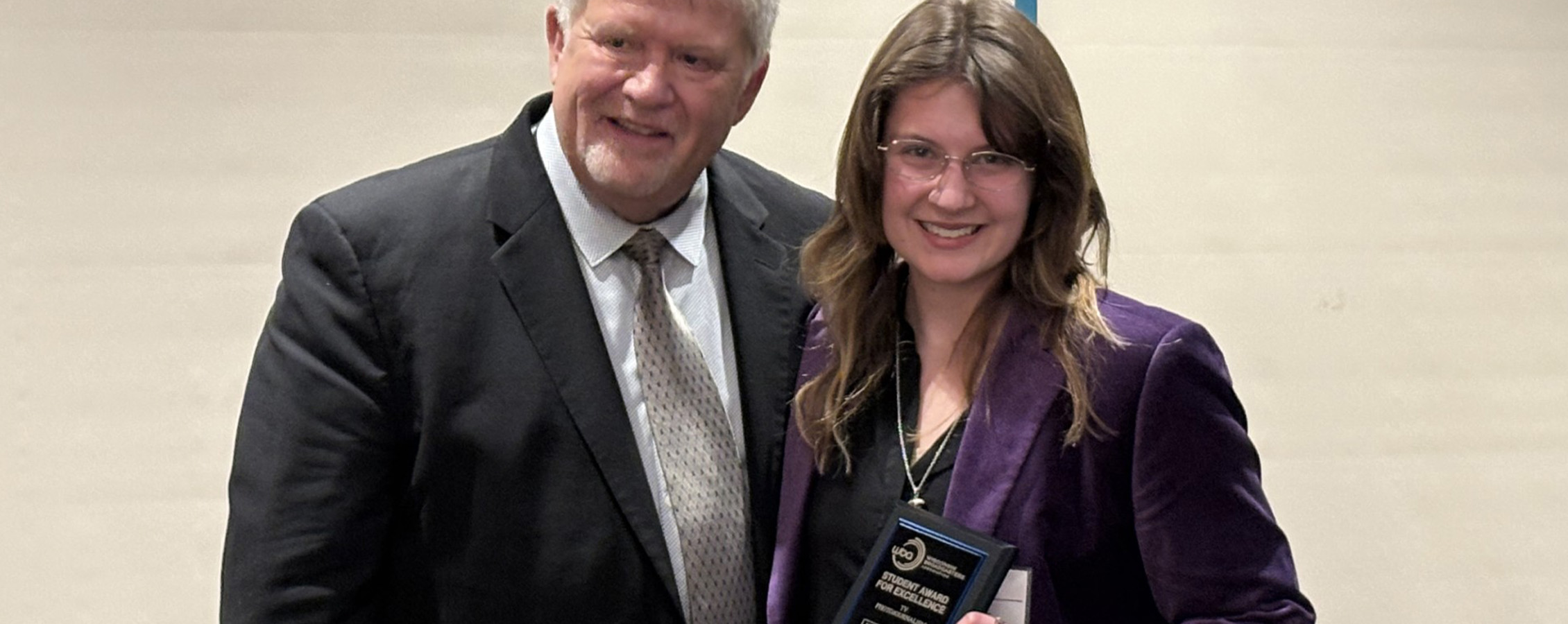 UW-Whitewater student Eydie Furnett showing her first place plaque for photojournalism