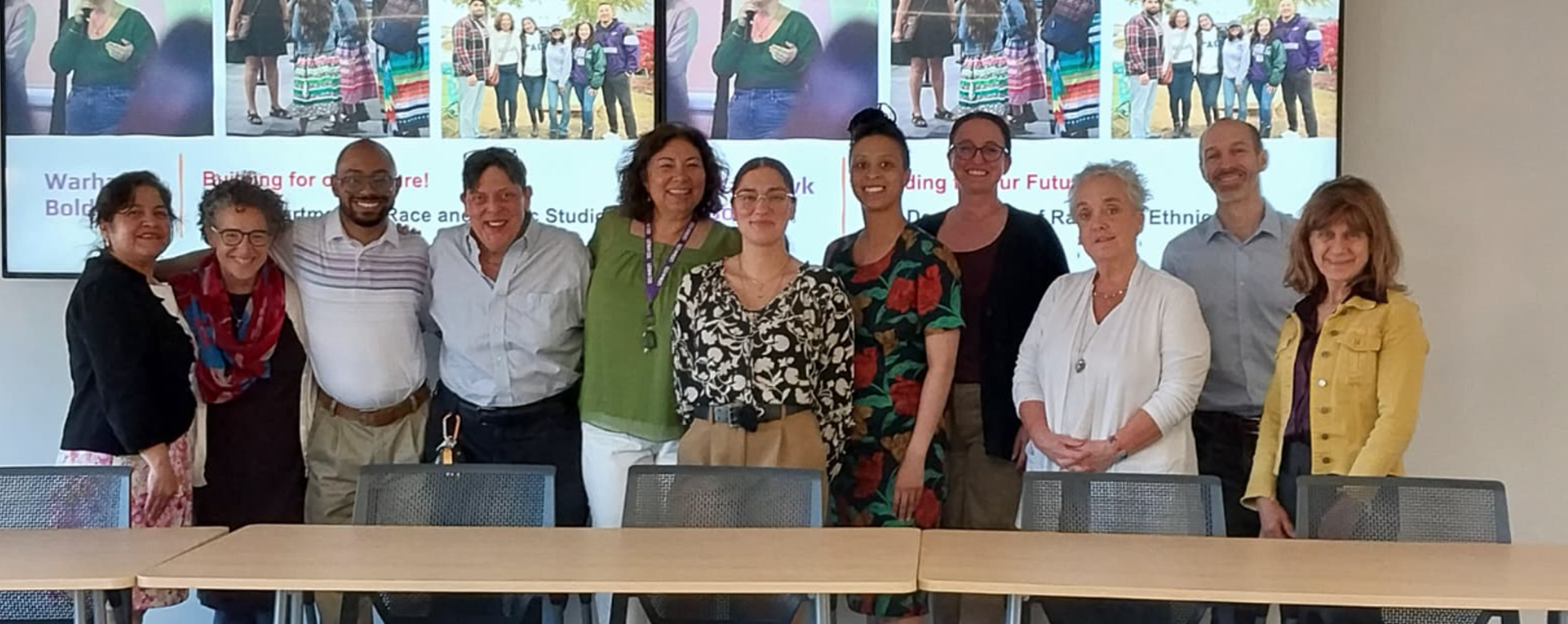 Race and Ethnic Studies faculty and Interim Provost Fox pose for a group photo in a classroom.