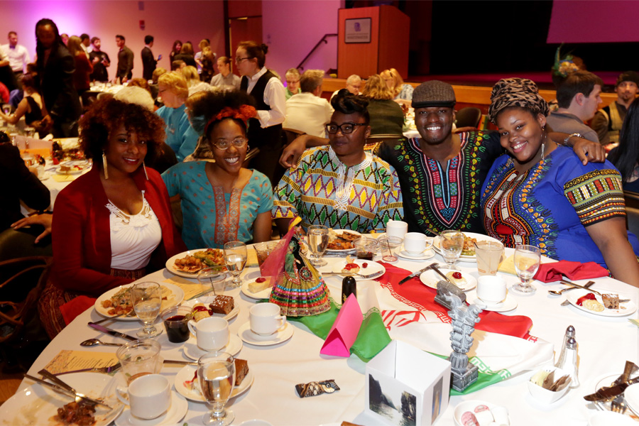 Students sit at a table during the International Dinner.