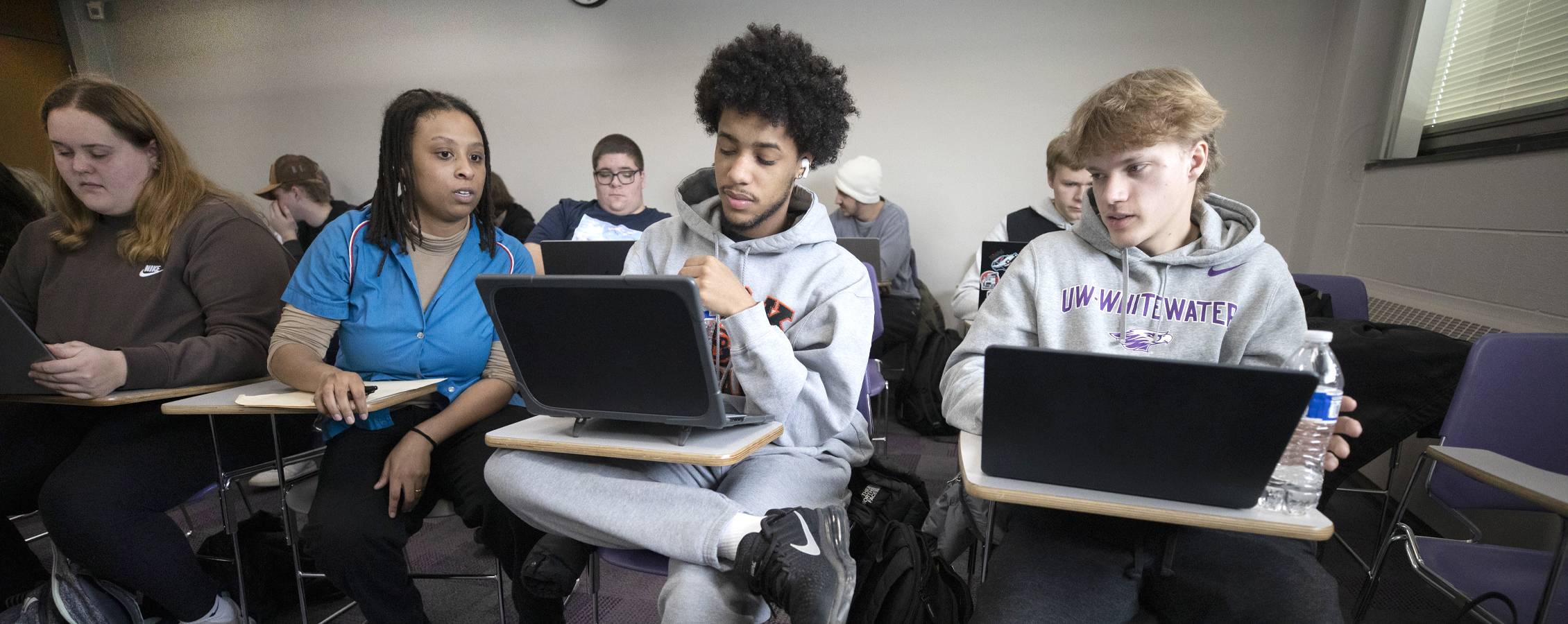 Students sit at desks in class.
