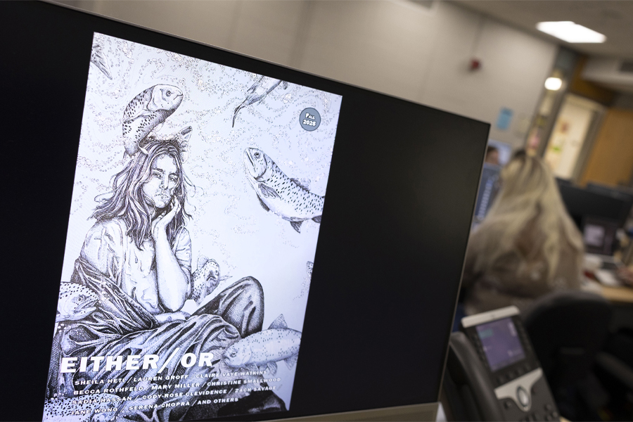 A computer screen shows a cover of Either/Or with a sketch of a feminine person.