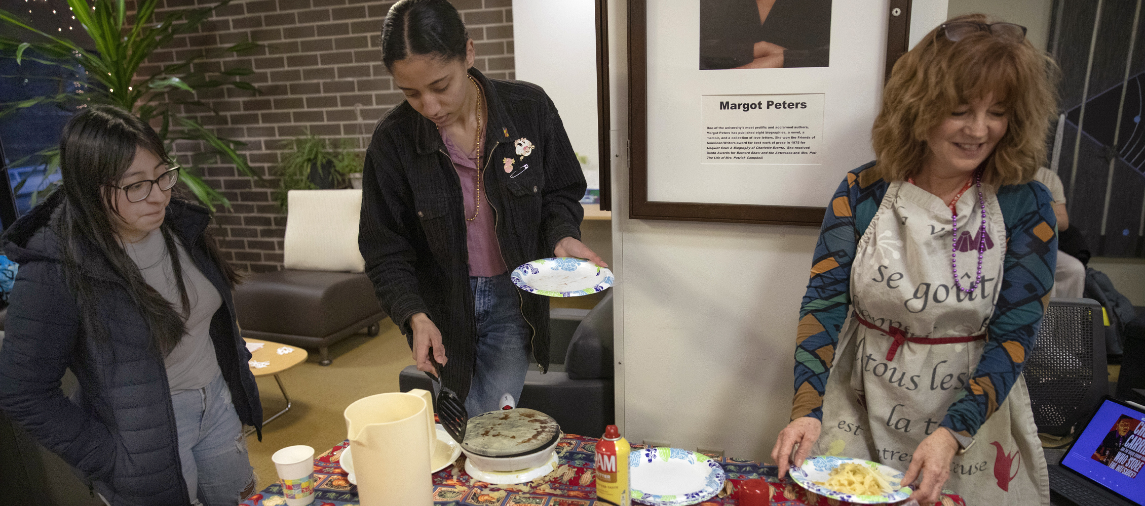 A faculty member and students make crepes.