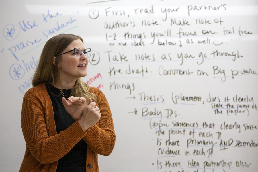 A person stands in front of a whiteboard.