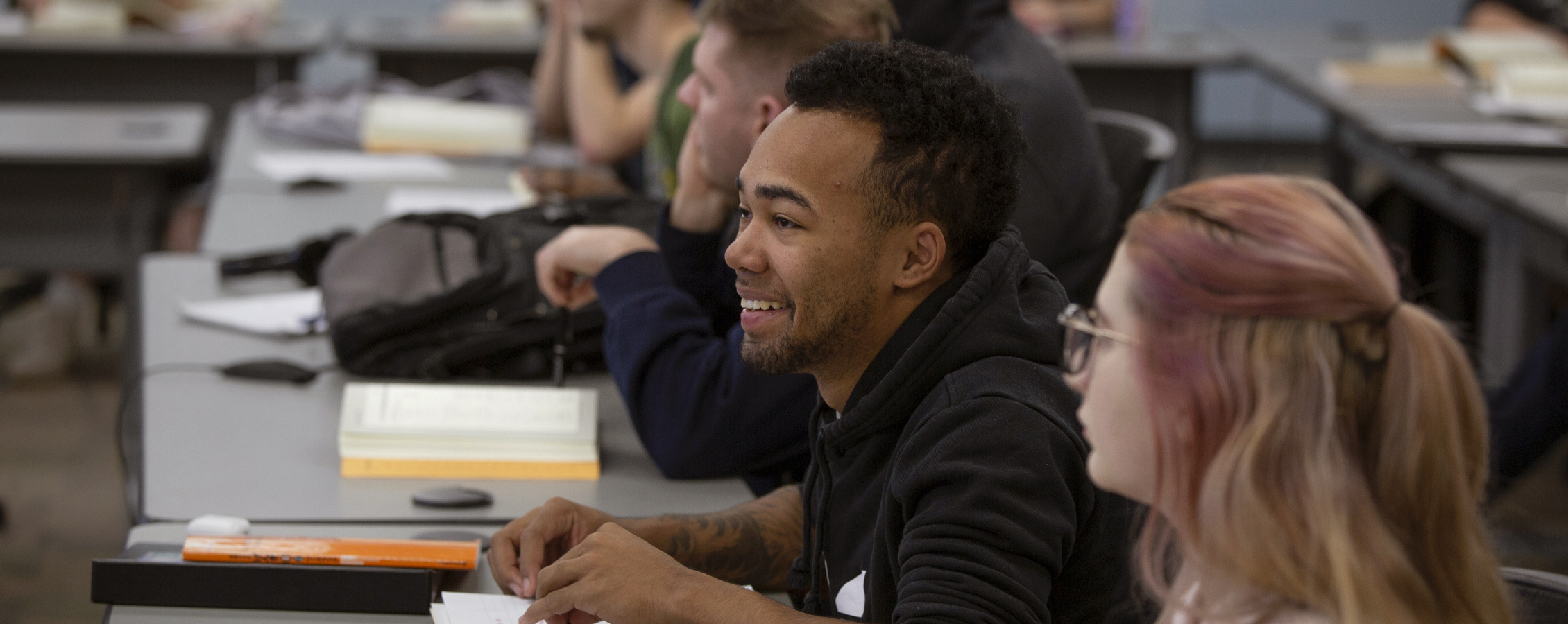 students listen and smile in a classroom