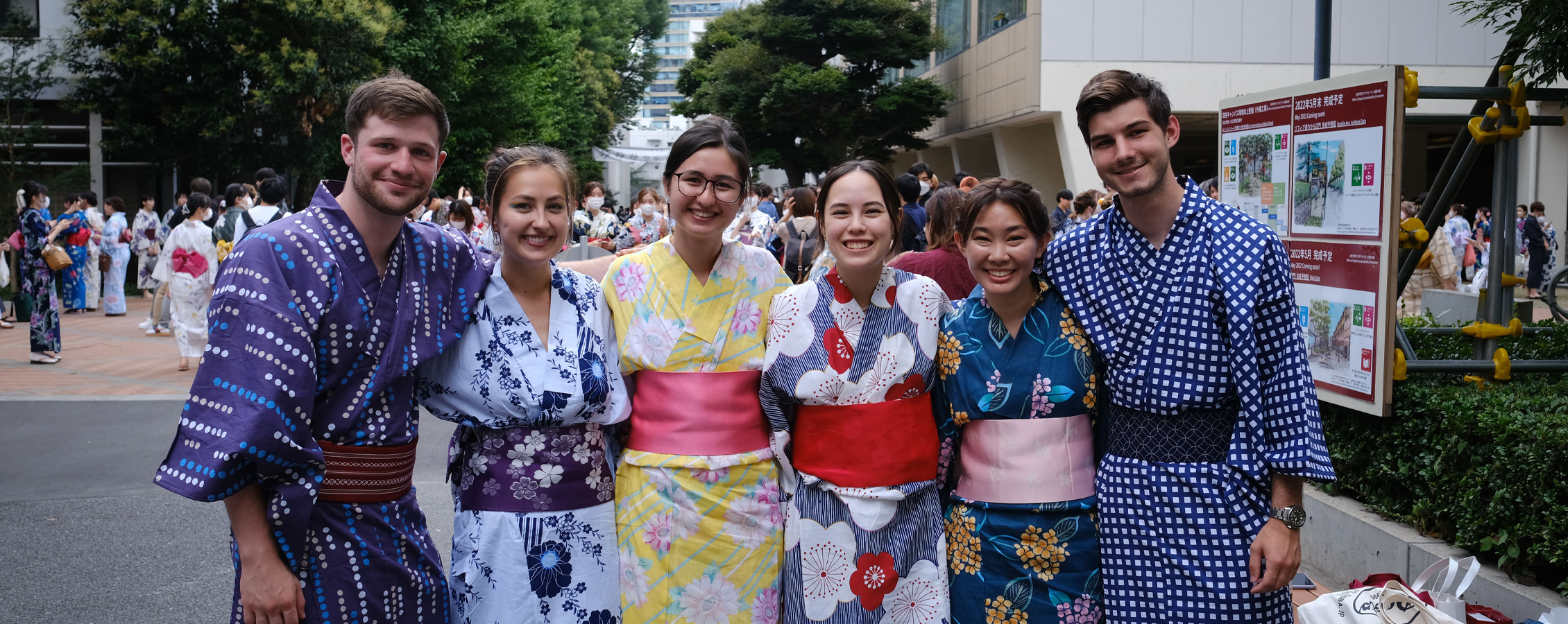 Students pose together while wearing obis in Japan.