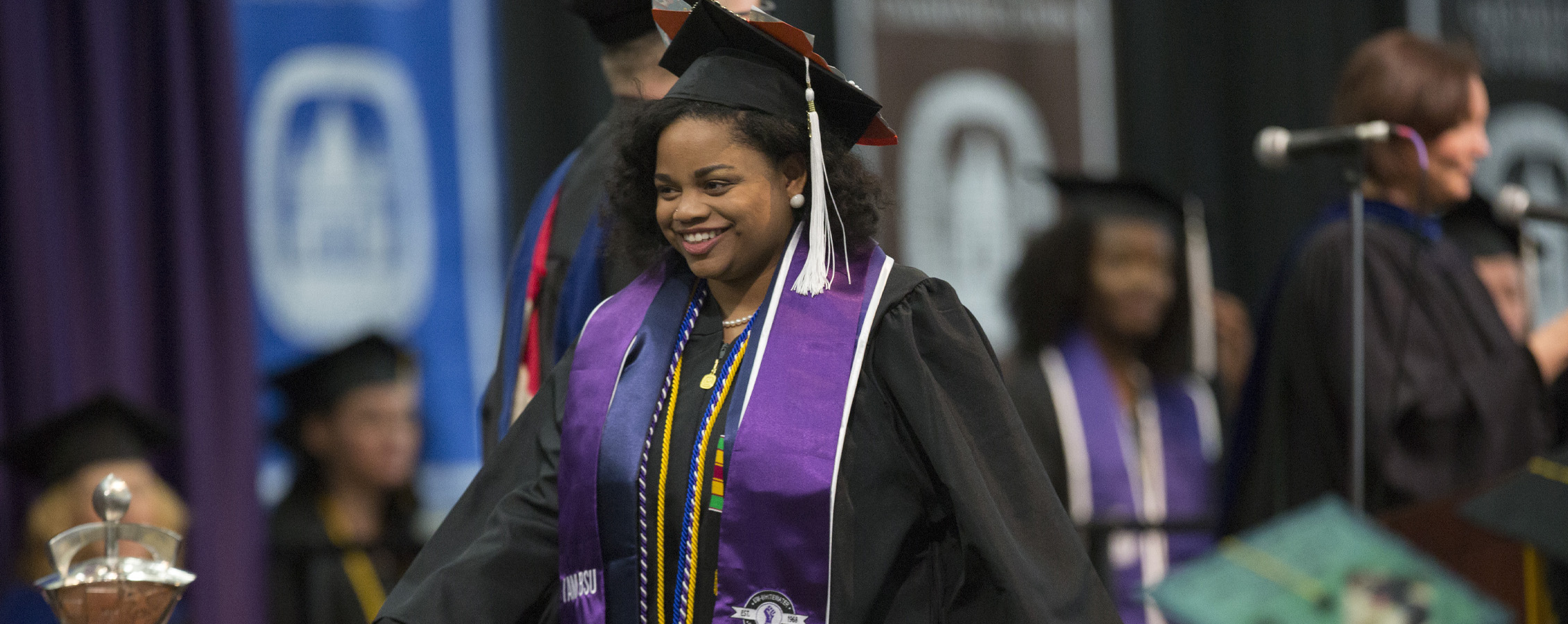 A student crosses the stage at graduation.